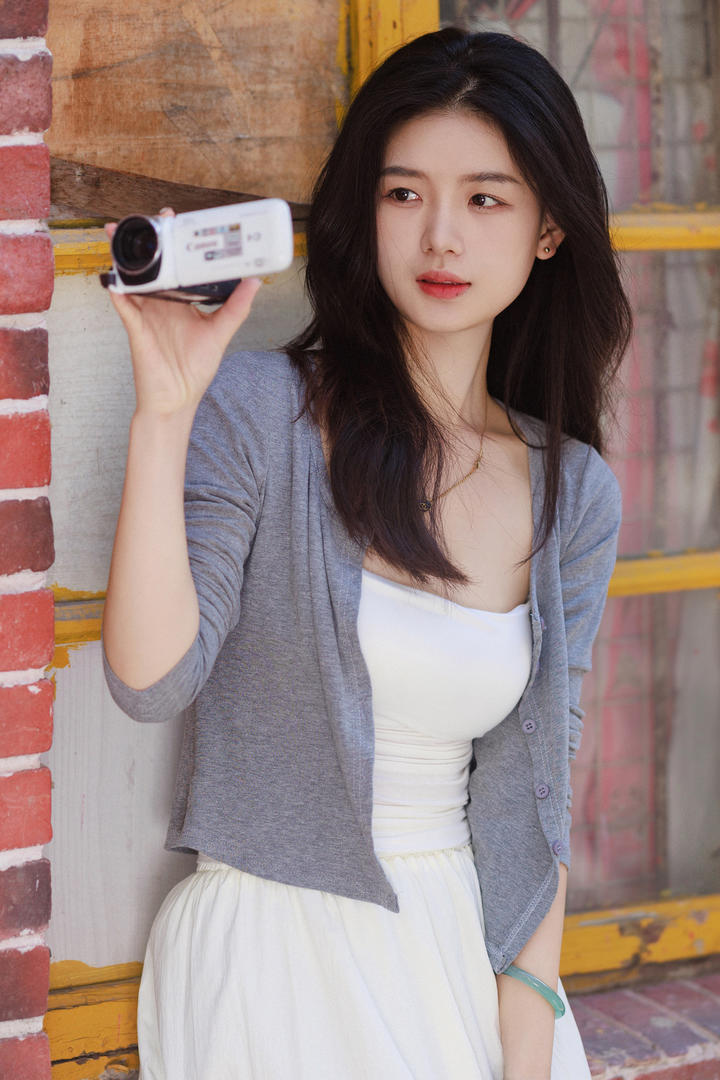 拿着摄像机拍摄的漂亮女孩图片