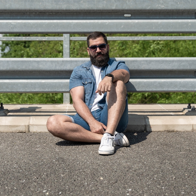 戴墨镜坐在地上的络腮胡帅哥图片