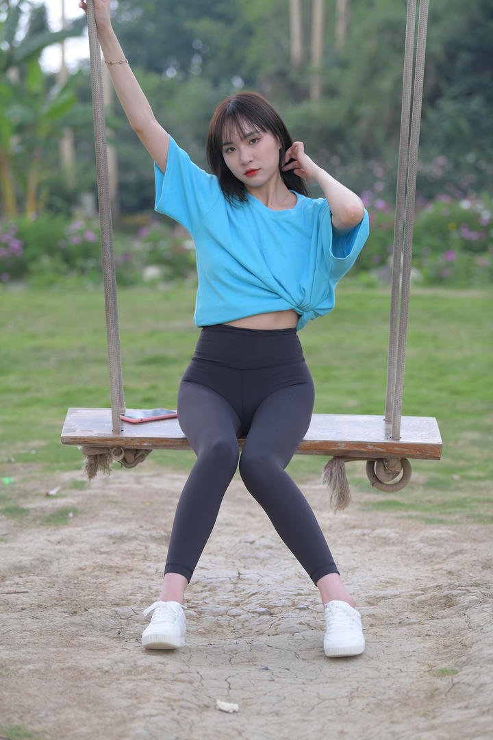 公园里荡秋千的紧身裤街拍美女图片