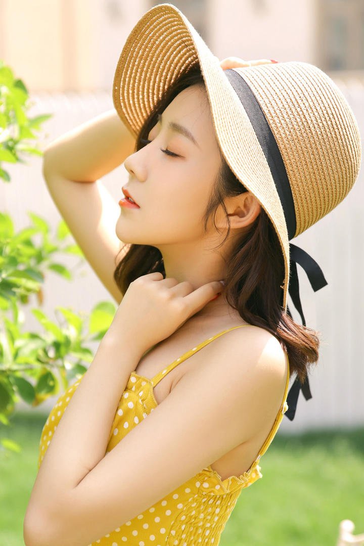 穿着黄色波点吊带裙的气质美女摄影写真图片
