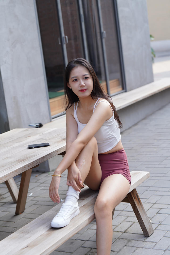 坐在板凳上的红色瑜伽短裤美眉国产3A街拍图片