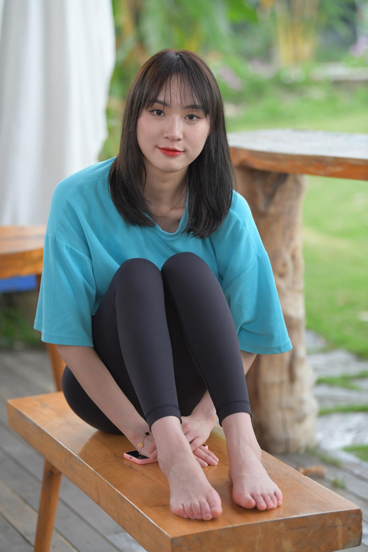 坐在长椅上的紧身裤美女街拍美女图片
