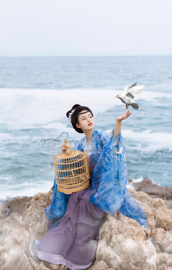 海边礁石上的古装汉服美女唯美艺术照图片