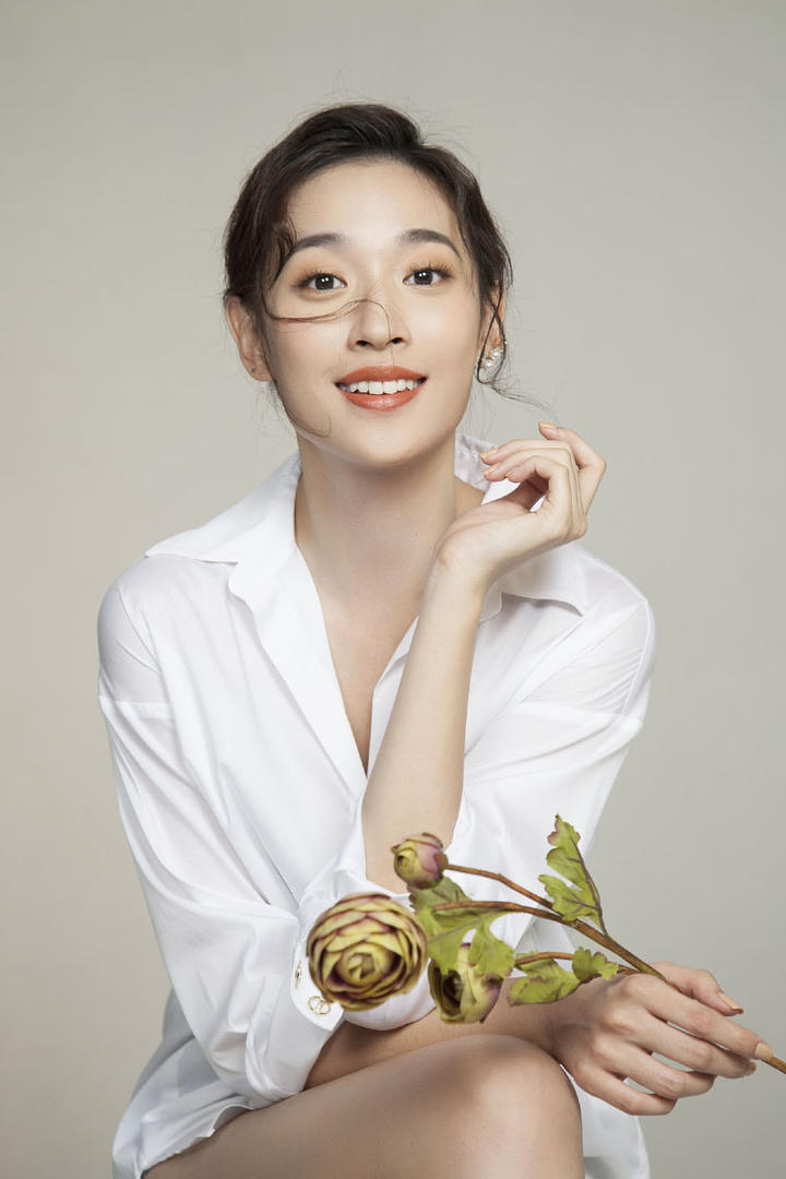 拿着花朵的气质女星张馨比性感写真图片