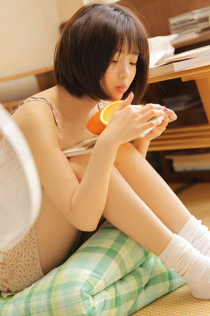 吃橘子的清纯短发美女图片